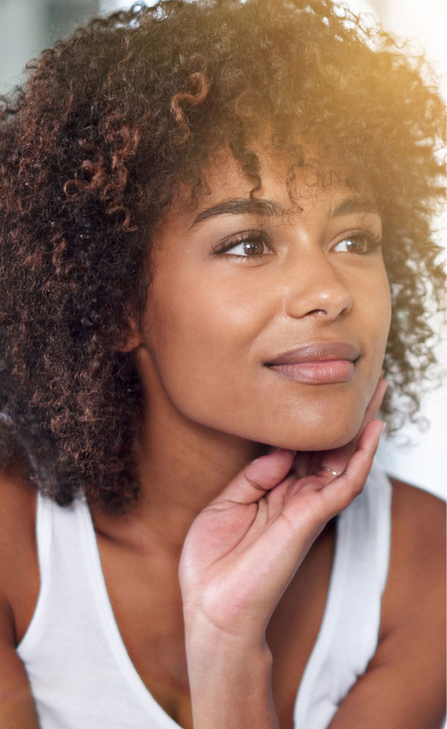 Thoughtful woman with curly hair and soft expression