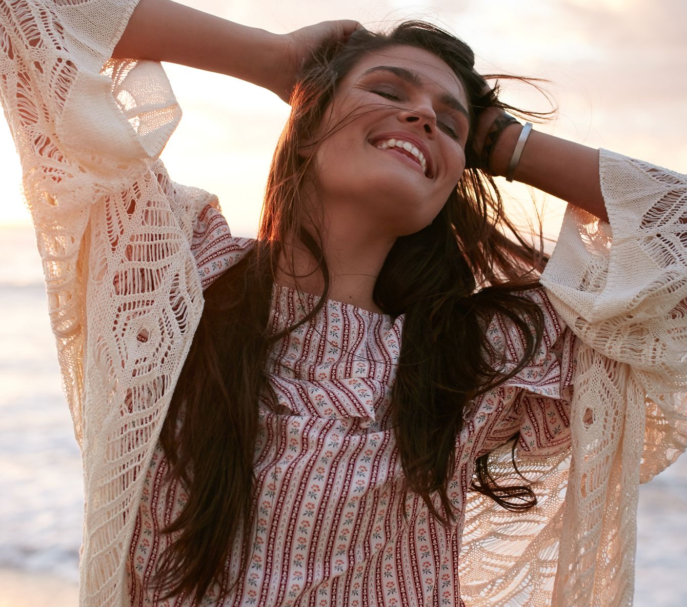 Woman enjoying the sunset by the beach.