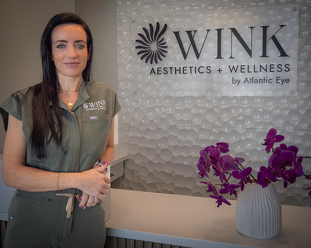 Woman standing in WINK Aesthetics + Wellness.