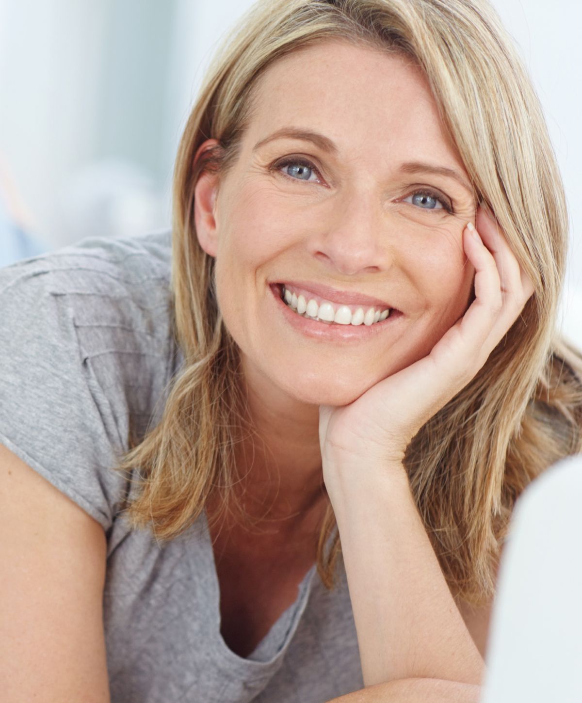 Close-up portrait of a young woman smiling.