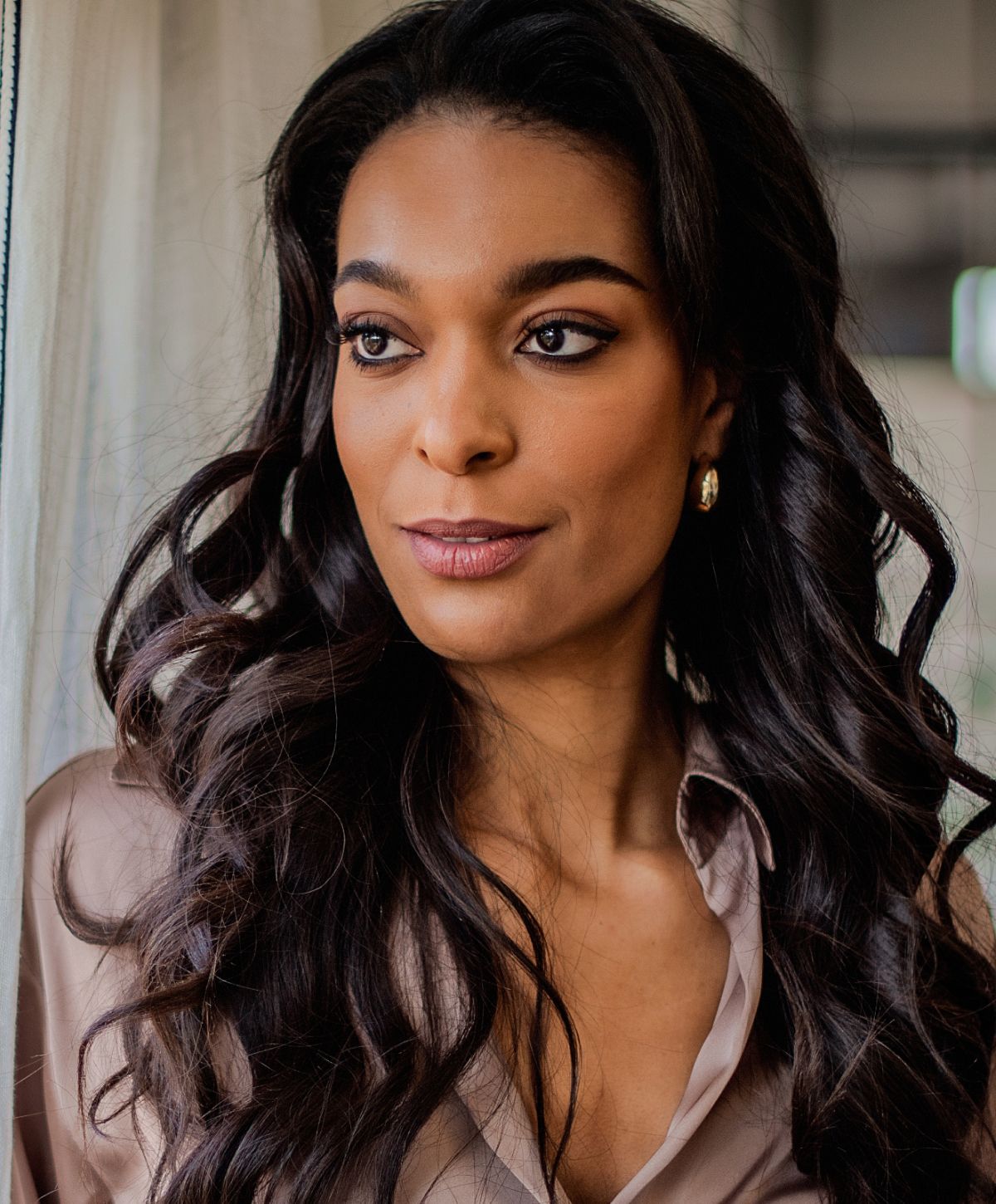 Close-up portrait of a young woman smiling.