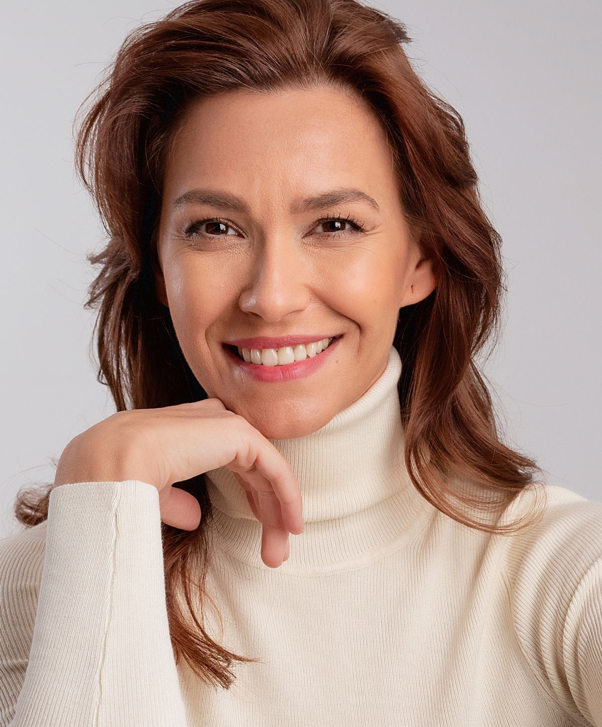 Confident woman in professional attire smiling.
