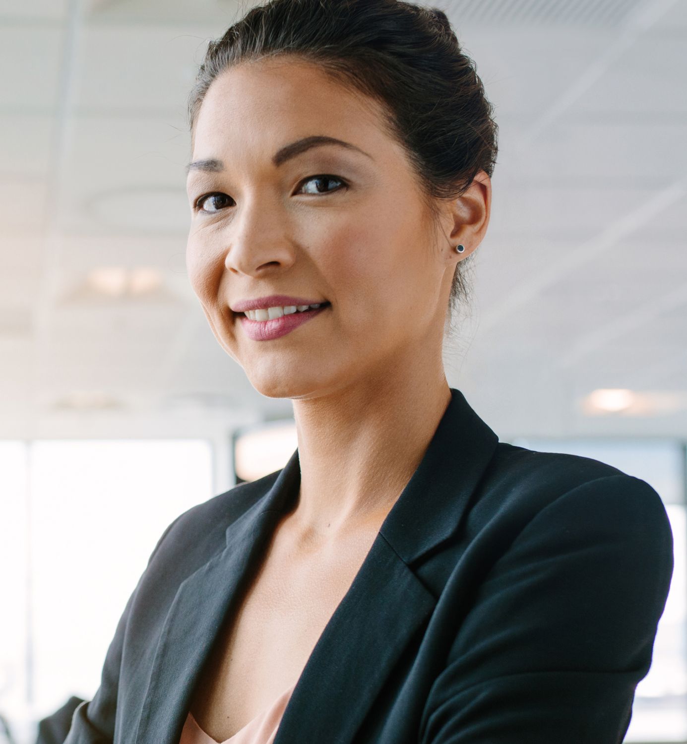 Confident woman in professional attire smiling.