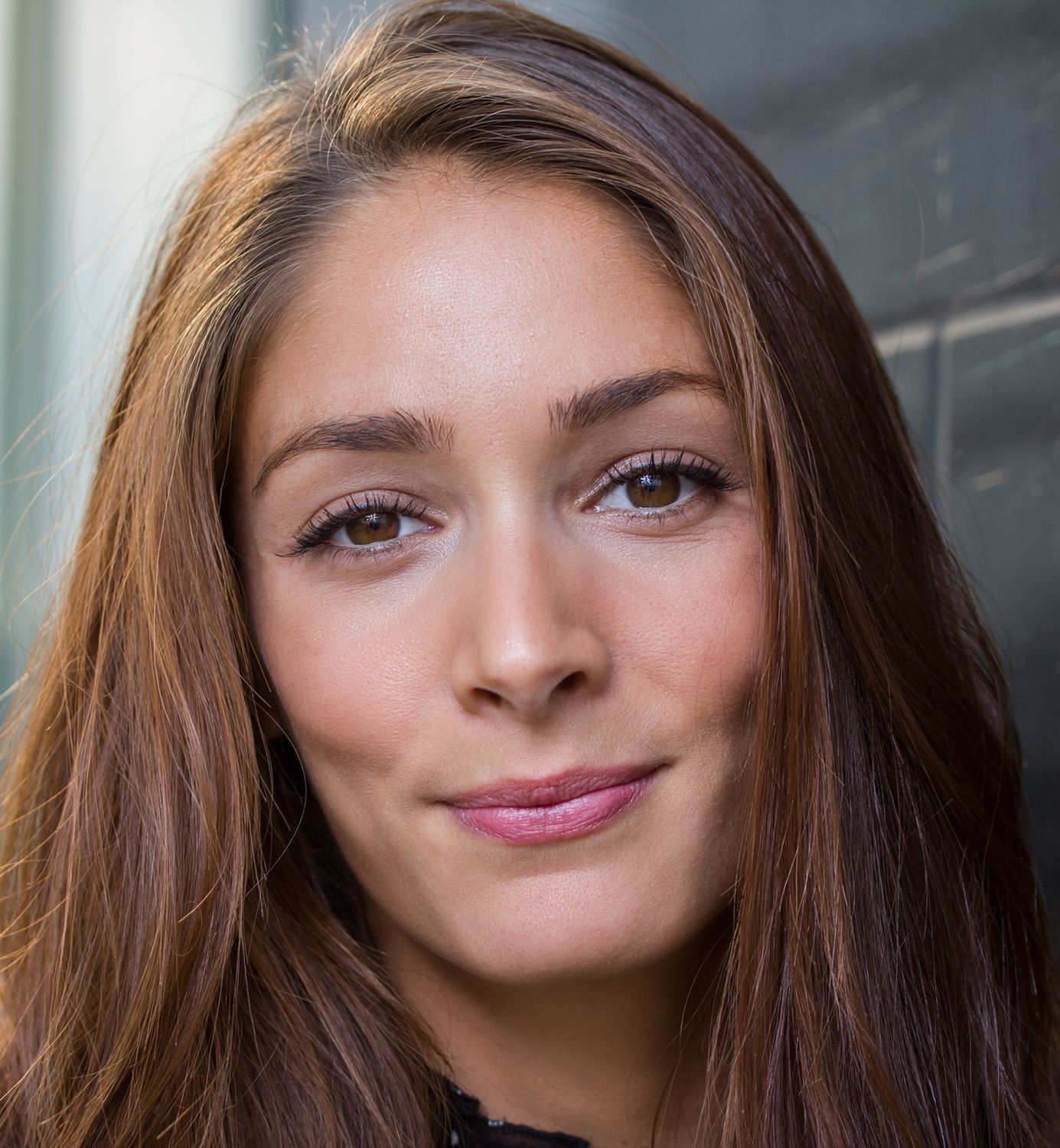 Close-up portrait of a young woman smiling.