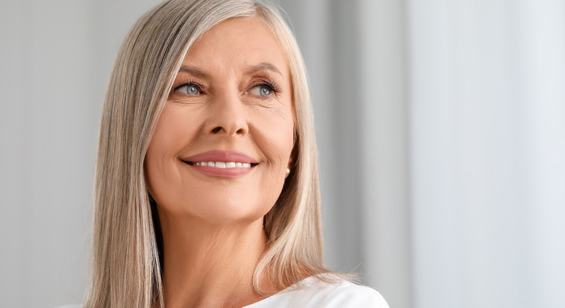 Smiling older woman with long gray hair.