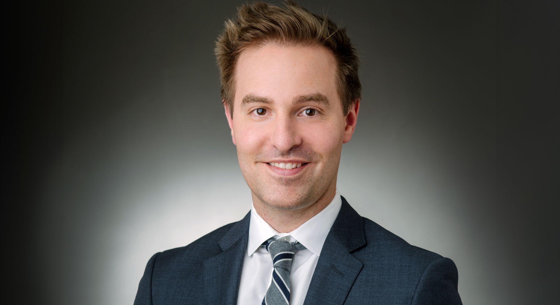 Smiling man in a suit portrait.