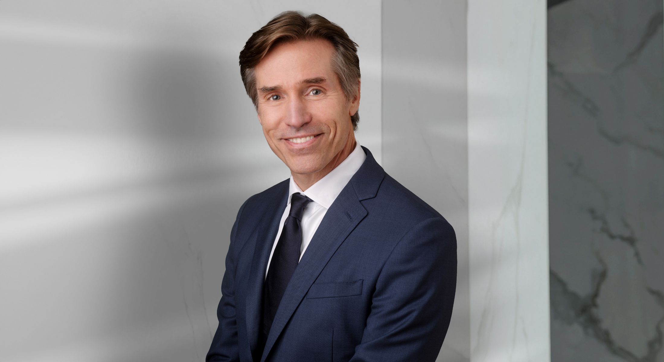 Professional man in a suit smiling confidently.