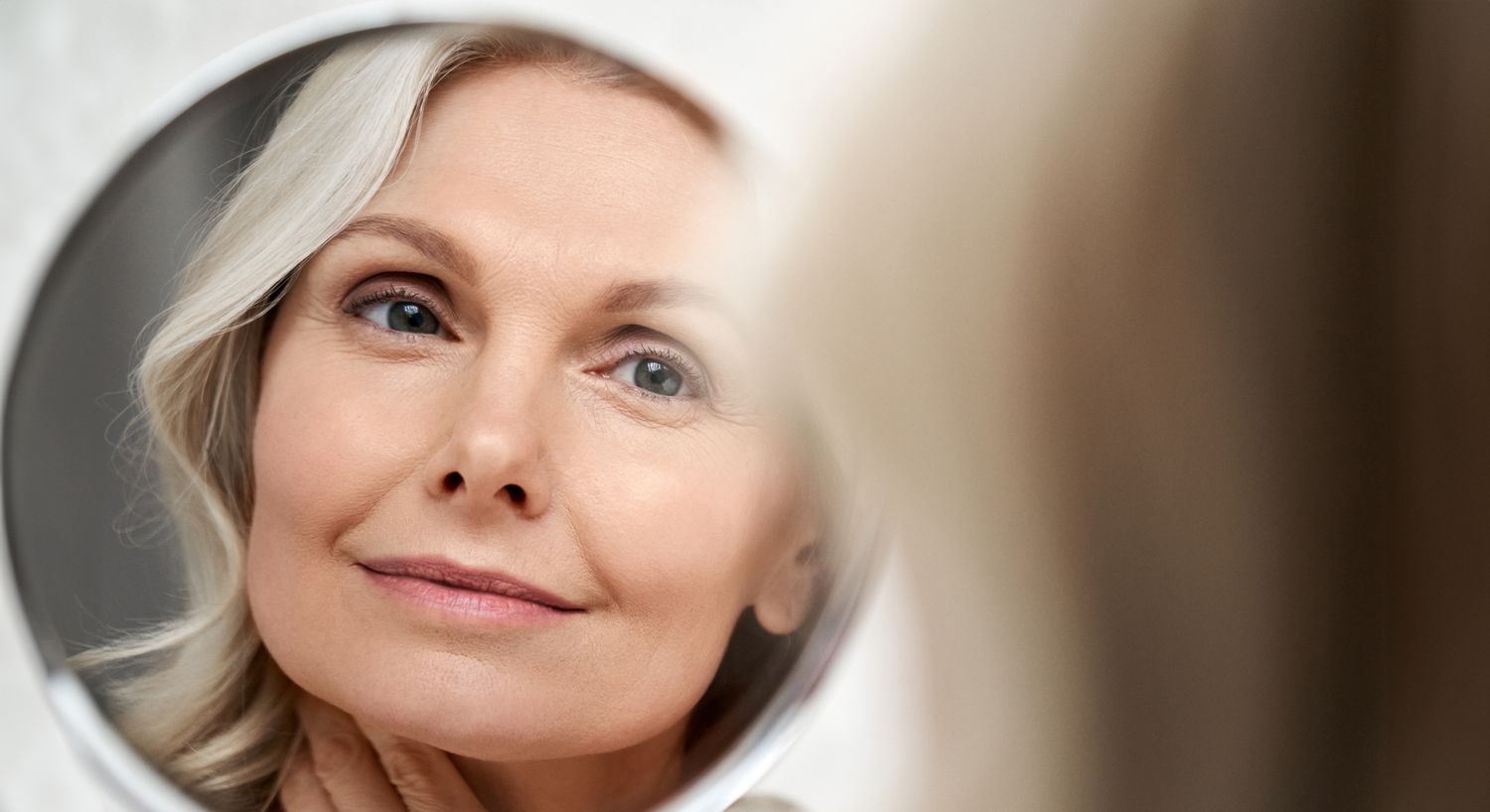 Woman admiring her reflection in a mirror.