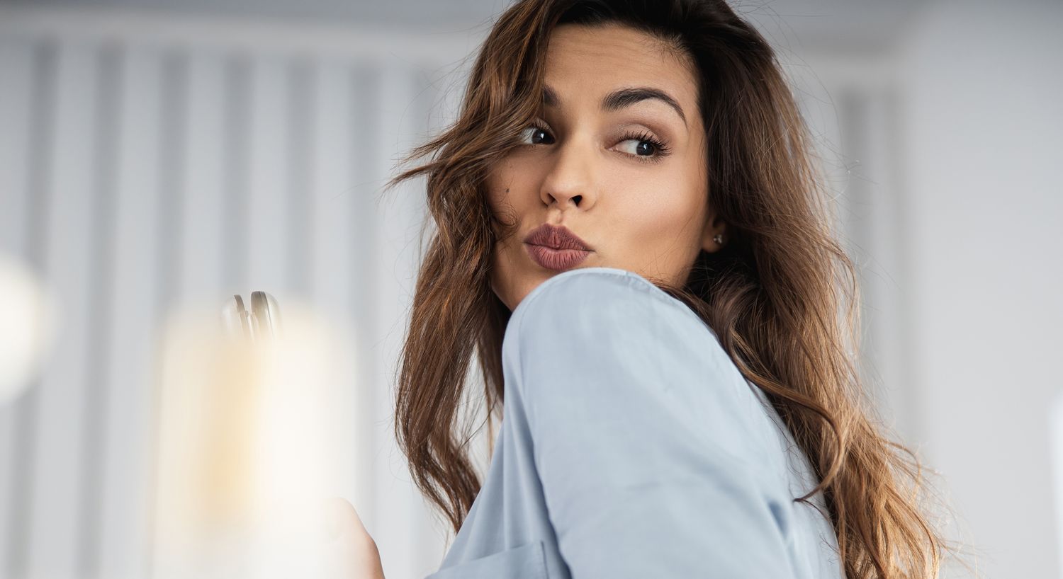 Woman playfully looking over her shoulder.